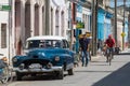 Blue american vintage car in the province Villa Clara with street life view