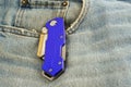 Blue anodized contractors razor knife on jeans