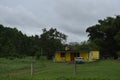 Blue antique car parked in front of a yellow house in rural VInales Royalty Free Stock Photo