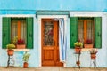 Blue aqua colored house with flowers and plants. Colorful houses in Burano island near Venice, Italy. Venice postcard. Famous Royalty Free Stock Photo