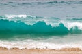 Blue and aquamarine color sea waves and yellow sand with white foam. Marine beach background.