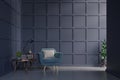 Blue armchair against dark blue wall with cabinet,table,lamp,book in living room interior with plants. Royalty Free Stock Photo