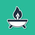 Blue Aroma candle icon isolated on green background. Vector Royalty Free Stock Photo