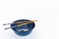 Blue asian porcelain bowl with chopsticks.