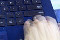 Singapore - SEPTEMBER 30, 2019: blue asus laptop fingers hand press type fast double exposure typing up down left right blur