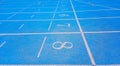 Blue athletic track with the numbers of the lanes
