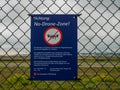 Blue Attention No-Drone-Zone Sign at Fence in Front of Fraport Frankfurt Airport, Germany