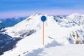 Blue attention sign on winter Caucasus mountains