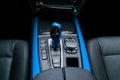 Blue Automatic gear stick transmission of a modern car, multimedia and navigation control buttons. Car interior details. Royalty Free Stock Photo