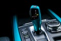 Blue Automatic gear stick transmission of a modern car, multimedia and navigation control buttons. Car interior details. Royalty Free Stock Photo