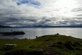 Blue autumn fjord, man on park bench and boat Royalty Free Stock Photo