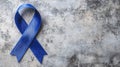 Blue Awareness Ribbon on Gray Textured Background Royalty Free Stock Photo