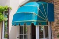 Blue awning over door and brick wall background.