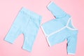 Blue baby clothes on pink background with shirt and trousers. Child design summer fashion Royalty Free Stock Photo