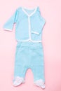 Blue baby clothes on pink background with shirt, trousers and white socks on pink background. Child design summer fashion. Flat Royalty Free Stock Photo