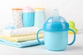 Blue baby cup - baby stuff Royalty Free Stock Photo