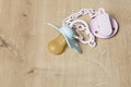 Blue baby pacifier with pink chain Royalty Free Stock Photo