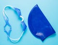 blue baby swimming cap baby goggles for the pool  blue background. swimming lesson  healthy lifestyle Royalty Free Stock Photo