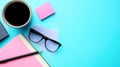 A blue background with a cup of coffee, a pen, a pair of glasses Royalty Free Stock Photo