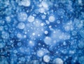 Blue background design with layers of white bokeh lights or blurred, out of focus stars or falling rain or snow in random pattern Royalty Free Stock Photo