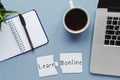 Blue background flatlay, inscription learn online on a puzzle, computer, education concept Royalty Free Stock Photo