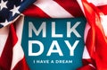 Blue background framed with American Flag and text abbreviation MLK. Happy Martin Luther King Day concept Royalty Free Stock Photo