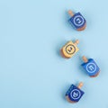 Blue background with multicolor dreidels. Hanukkah and judaic ho Royalty Free Stock Photo