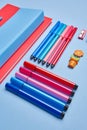 On a blue background, notebooks, pens, markers, elastics and paper clips. Royalty Free Stock Photo