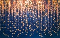 A blue background with outoffocus golden lights forming a pattern of blurry circles, creating an abstract, festive, and elegant Royalty Free Stock Photo