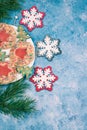 On a blue background, a plate with handmade Christmas cookies and Christmas snowflakes . Vertical orientation. Copy