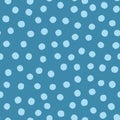 Blue background with scattered round spots. Seamless pattern with dots painted rough brush.