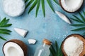 Blue background with set of organic coconut products for spa treatment, cosmetic or food ingredients. Oil, water and shavings. Royalty Free Stock Photo