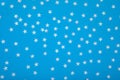 Blue background with shiny iridescent pearl stars