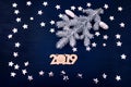 Blue background stars christmas tree branch white bump notebook letters symbols 2019 decoration top view greeting card