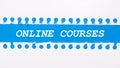 On a blue background with text ONLINE COURSES two white torn strips of paper Royalty Free Stock Photo