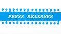 On a blue background with text PRESS RELEASES two white torn strips of paper