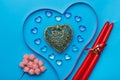 On a blue background, there is a heart made of transparent pebbles in the shape of hearts, next to a ribbon for Royalty Free Stock Photo