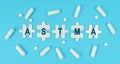 On a blue background, there are pills and puzzles with the inscription - ASTMA