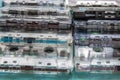On a blue background, there are two stacks of audio cassettes. Selective focus