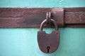 Old rusty padlock. On a blue background. View from the front Royalty Free Stock Photo