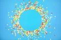Blue background with vivid confetti. Colorful abstract backdrop with round frame and space for your text. Festive