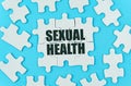 On a blue background are white puzzles with the inscription - SEXUAL HEALTH