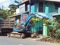 Blue backhoe on the street This backhoe is digging the ground