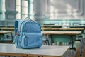 Blue Backpack on Classroom Desk in an Empty Schoolroom, Back to School Concept Royalty Free Stock Photo