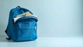 Stylish blue backpack ready for school or travel, filled with books and notebooks on a clean background Royalty Free Stock Photo