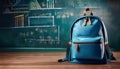 Blue backpack on desk in front of chalkboard with math equations Royalty Free Stock Photo