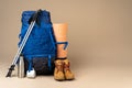 Blue backpack and hiking boots. Mountain gear close up Royalty Free Stock Photo