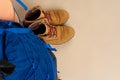 Blue backpack and hiking boots. Mountain gear close up Royalty Free Stock Photo