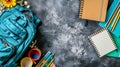 Blue backpack with school supplies on dark background Royalty Free Stock Photo