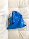 Blue Backpack in a white couch Royalty Free Stock Photo